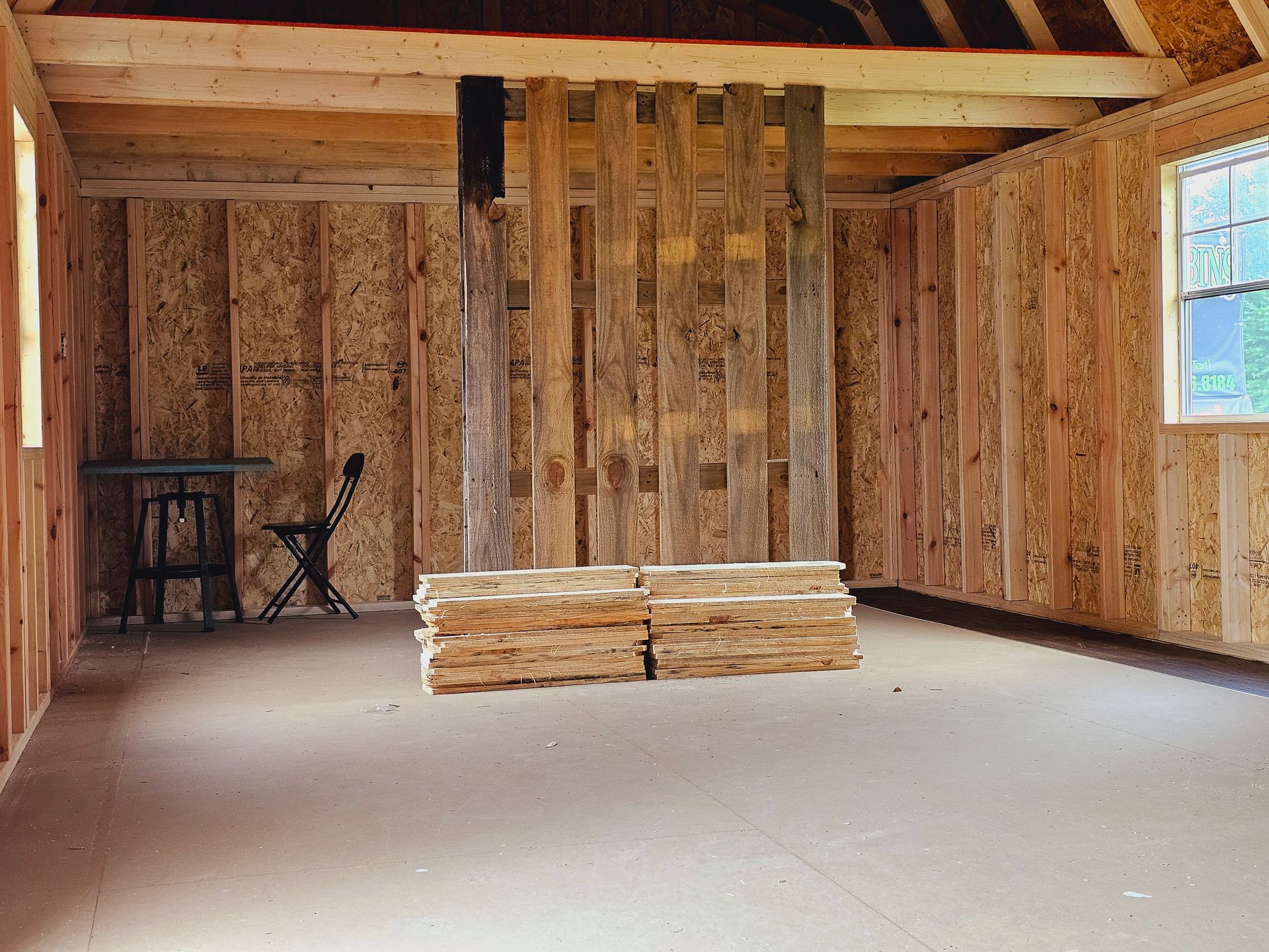 There is a stack of wood in the middle of the room.