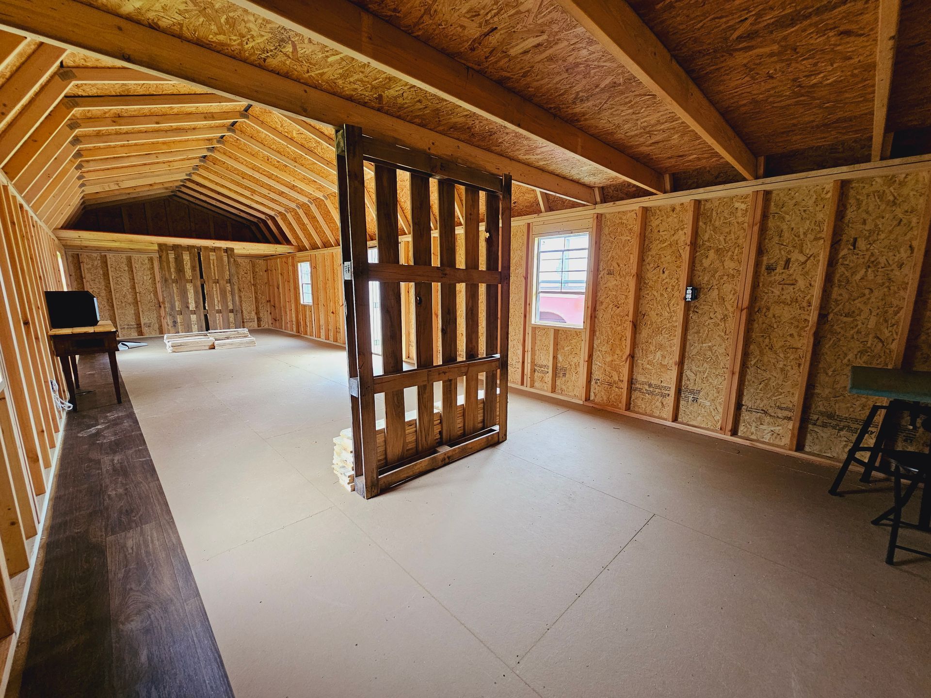 An empty room with a wooden wall and a window