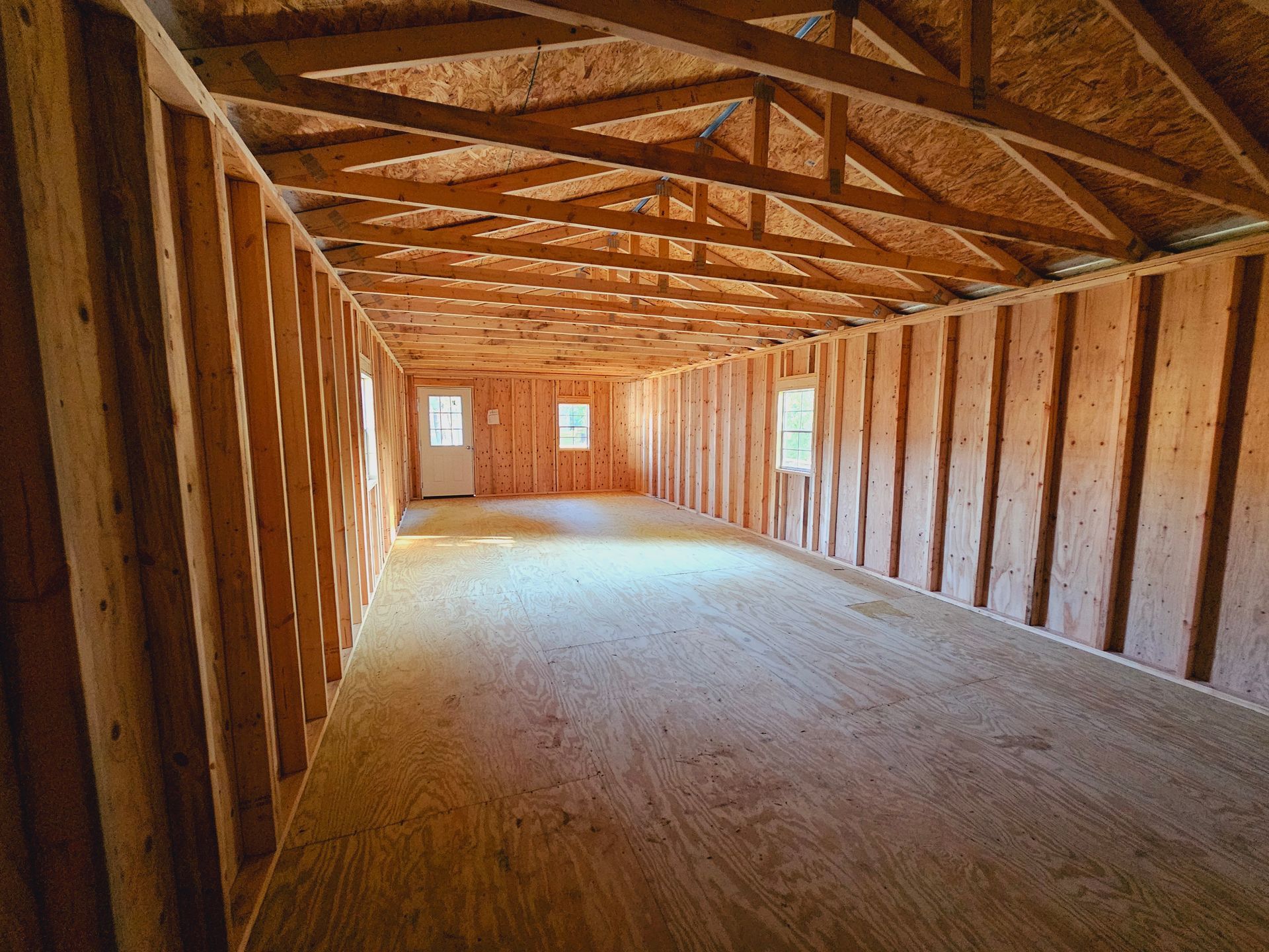 An empty room with wooden walls and a wooden floor.