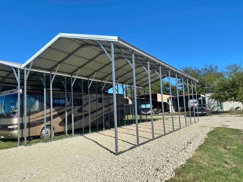 A rv is parked under a covered parking lot.