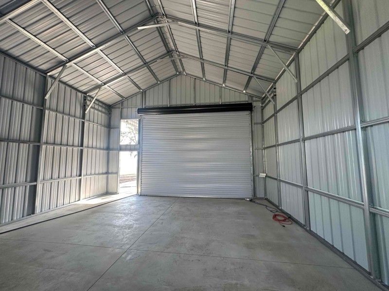 A large empty garage with a large garage door.