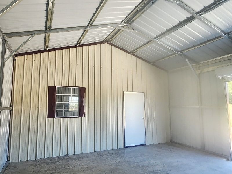 An empty garage with a window and a door