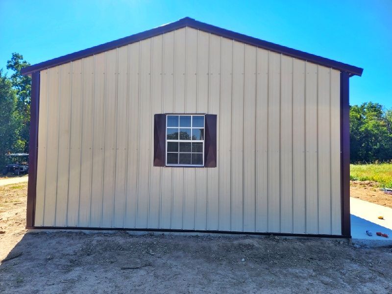 The side of a building with a window and shutters on it.