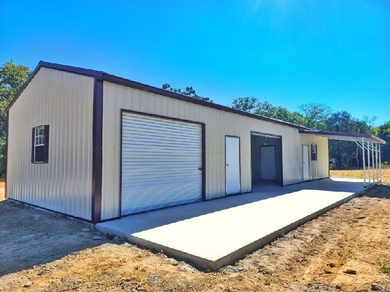 A large metal building with a garage and a porch.