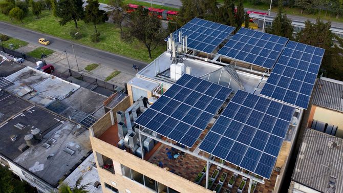 Rooftop solar panels on a building, generating electricity.