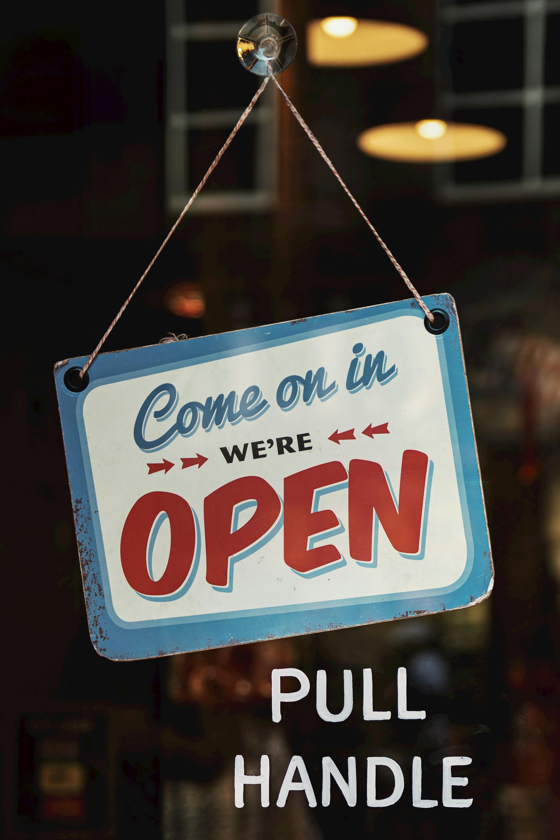 Sign hanging in a window that says