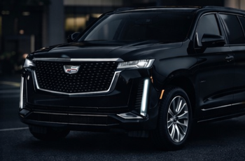 Black Cadillac Escalade SUV parked outside.