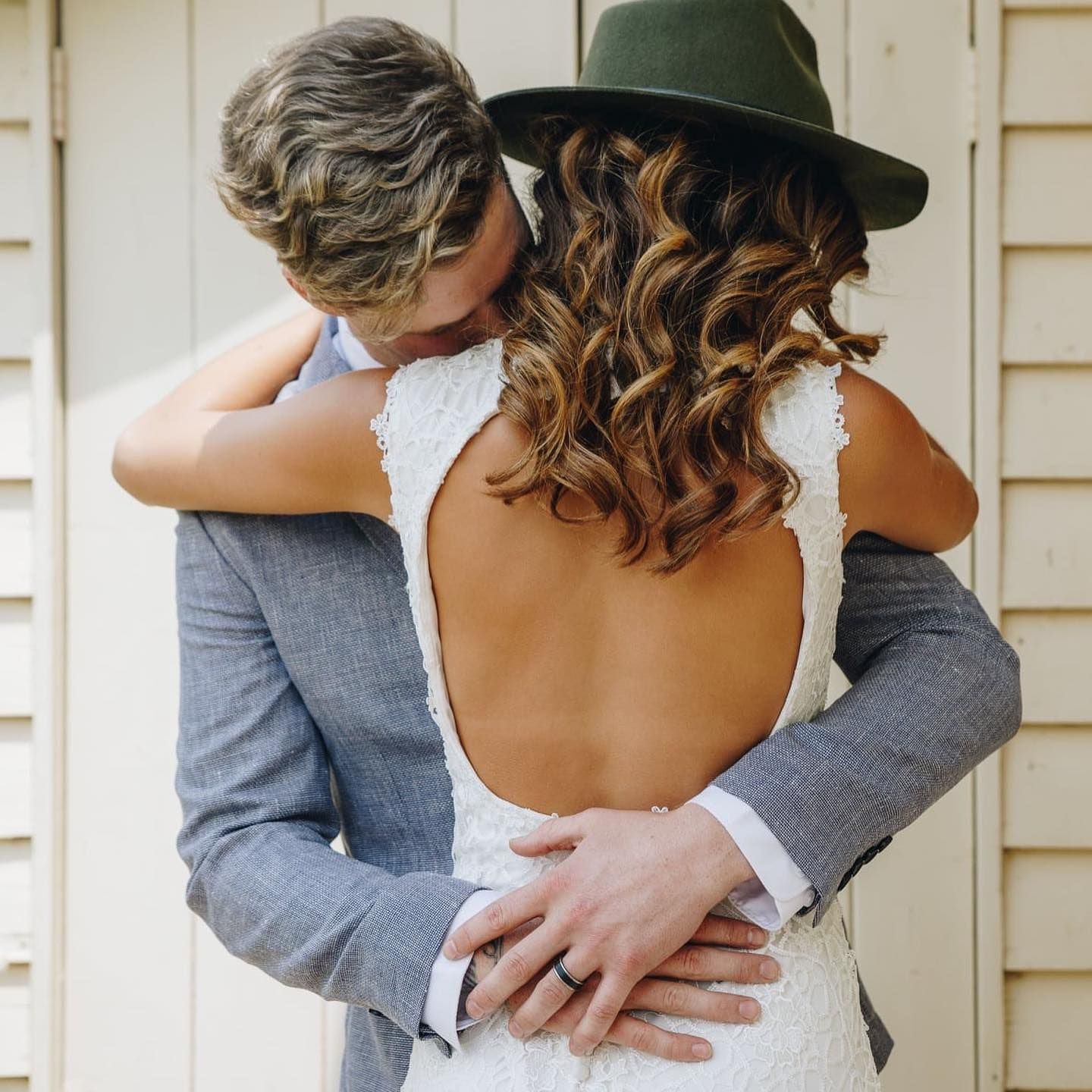 Couple hUgging. Bride in White Dress With Back Exposed — Lavish Hair in Shepparton, VIC