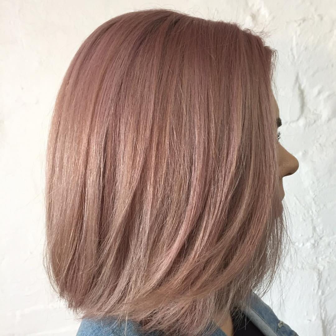 Woman With Angled, Rose-gold Bob Hairstyle Against a White Brick Wall — Lavish Hair in Shepparton, VIC
