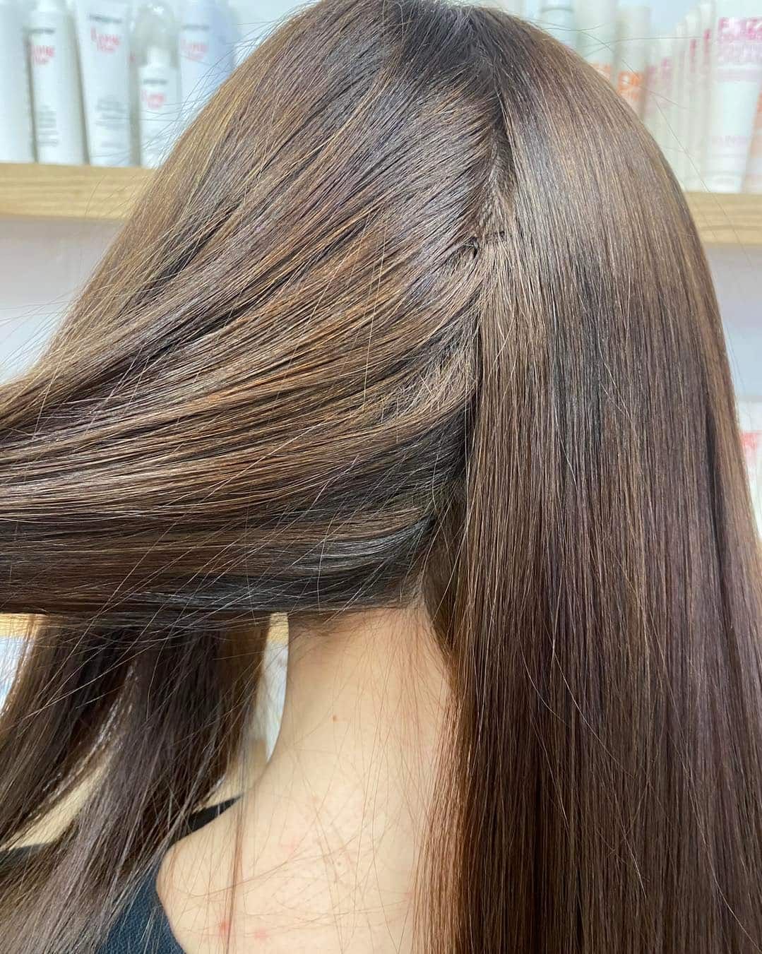 Close-up of Long Brown Hair Being Styled With a Crimper — Lavish Hair in Shepparton, VIC