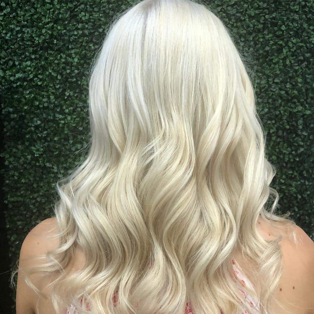 Blonde Wavy Hair, Shoulders Visible, Against a Green Leafy Background — Lavish Hair in Shepparton, VIC