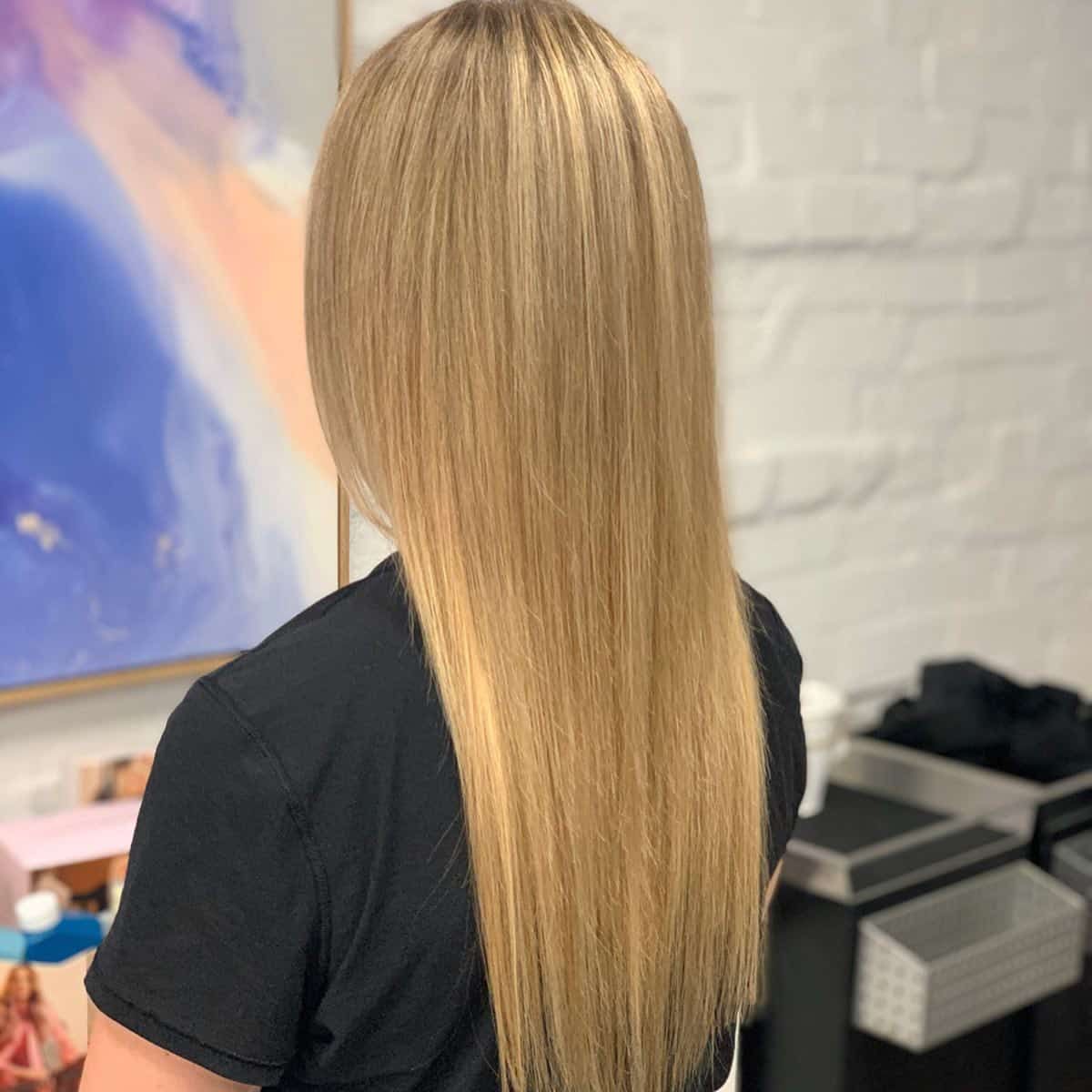 Woman With Long, Straight, Light Blonde Hair, Wearing a Black Shirt — Lavish Hair in Shepparton, VIC