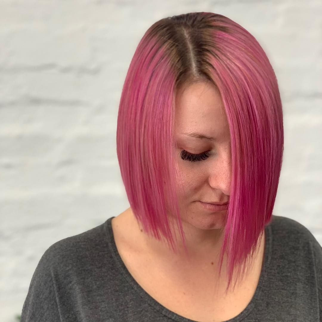 Woman With a Pink Bob Haircut, Gazing Downward, Dark Roots, Gray Shirt — Lavish Hair in Shepparton, VIC