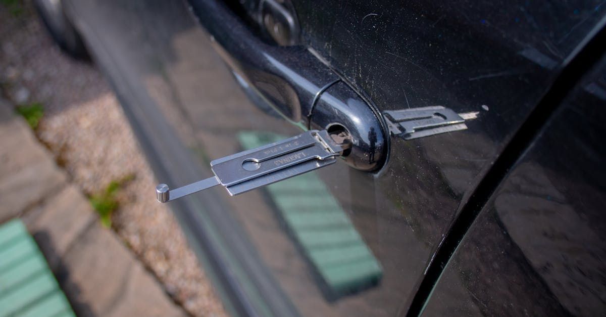 Close-up of a bicycle lock latch attached to a black bike frame