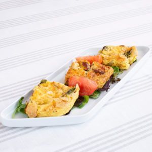A white plate topped with a variety of food on a table.