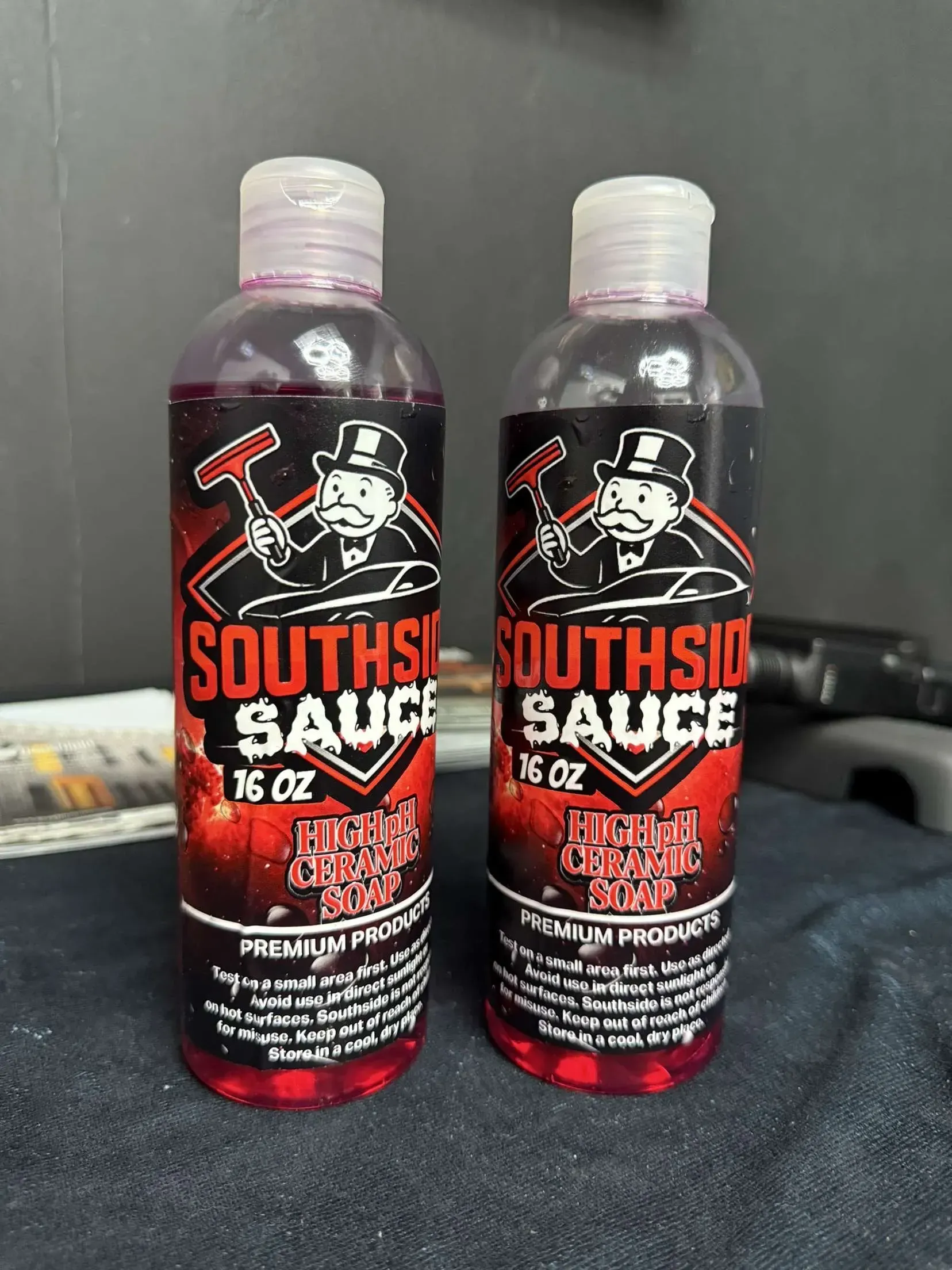 Two bottles of "Southside Sauce" with a red label and a cartoon man in a top hat.