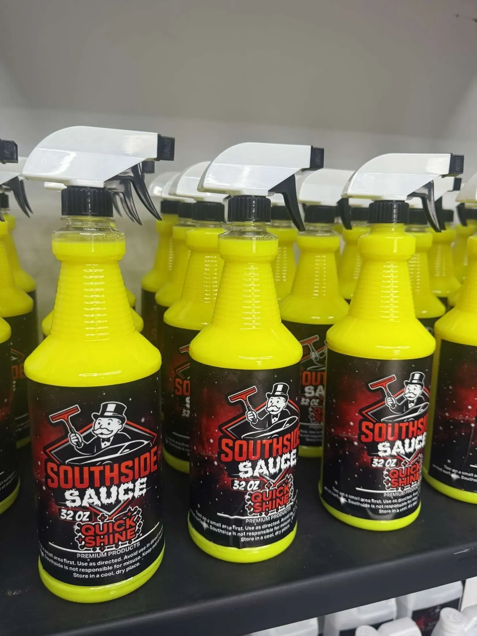 Yellow bottles of Southside Sauce cleaner with red and black labels, white spray tops.