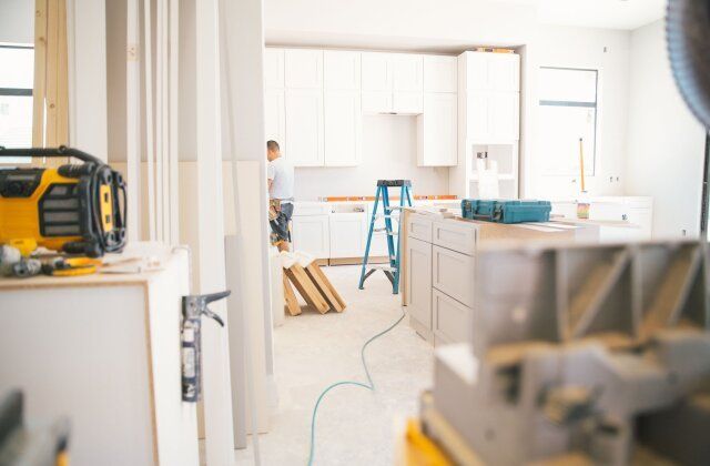 A kitchen under construction with a ladder in the background.