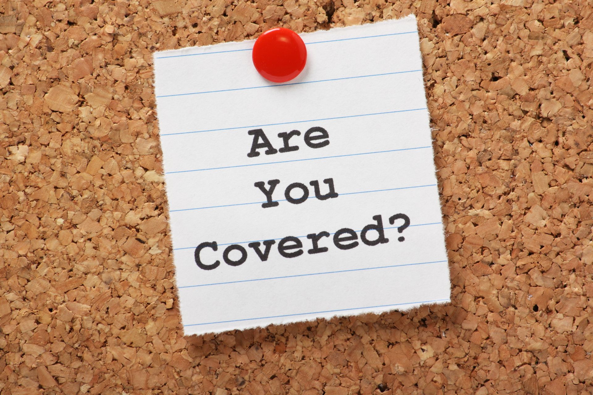 A note on a cork board asking if you are covered
