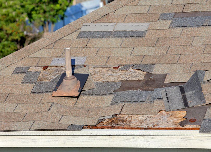 A close up of a roof with shingles missing