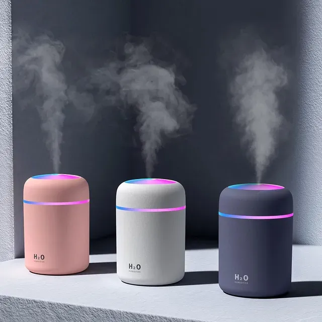 Three h2o humidifiers are sitting next to each other on a table.