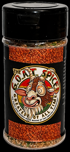 Clear Spice seasoning jar with red pepper flakes and black lid, labeled “The Heat Is On.”