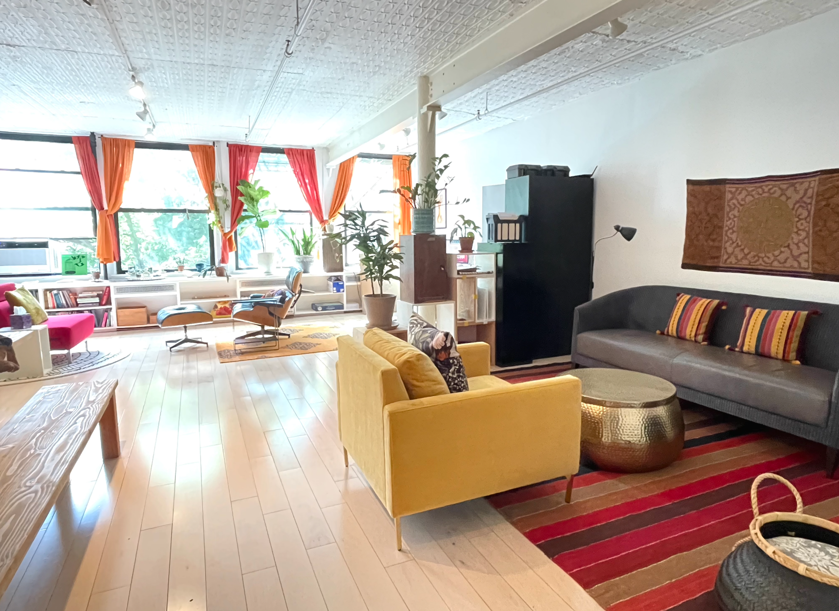 A living room with a yellow couch and a gray couch