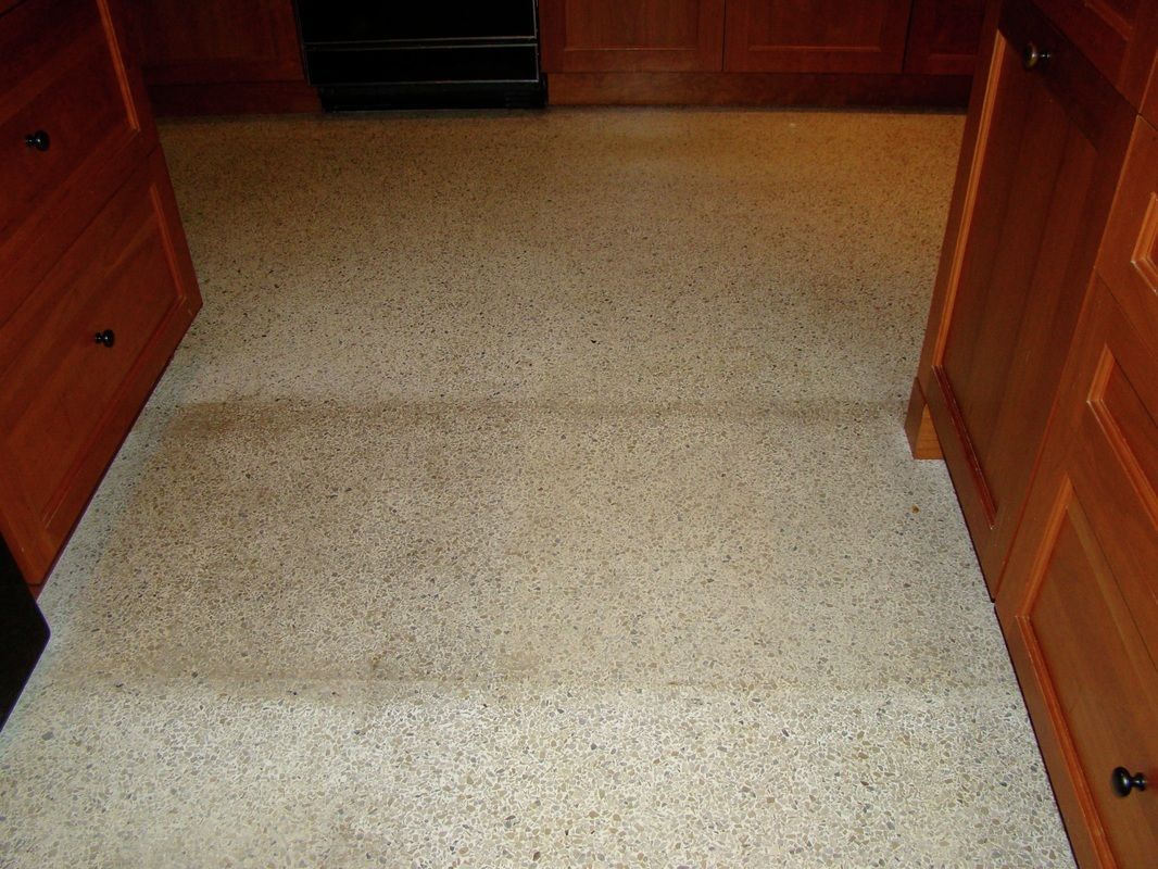 Brown cabinets frame a speckled