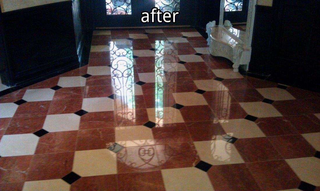 Two upright glass panels reflecting light on a checkered floor inside a building