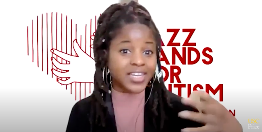 Woman with dreadlocks gesturing in front of a
