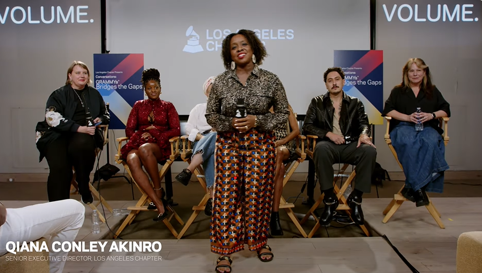 Panel discussion with six people on stage in front of a