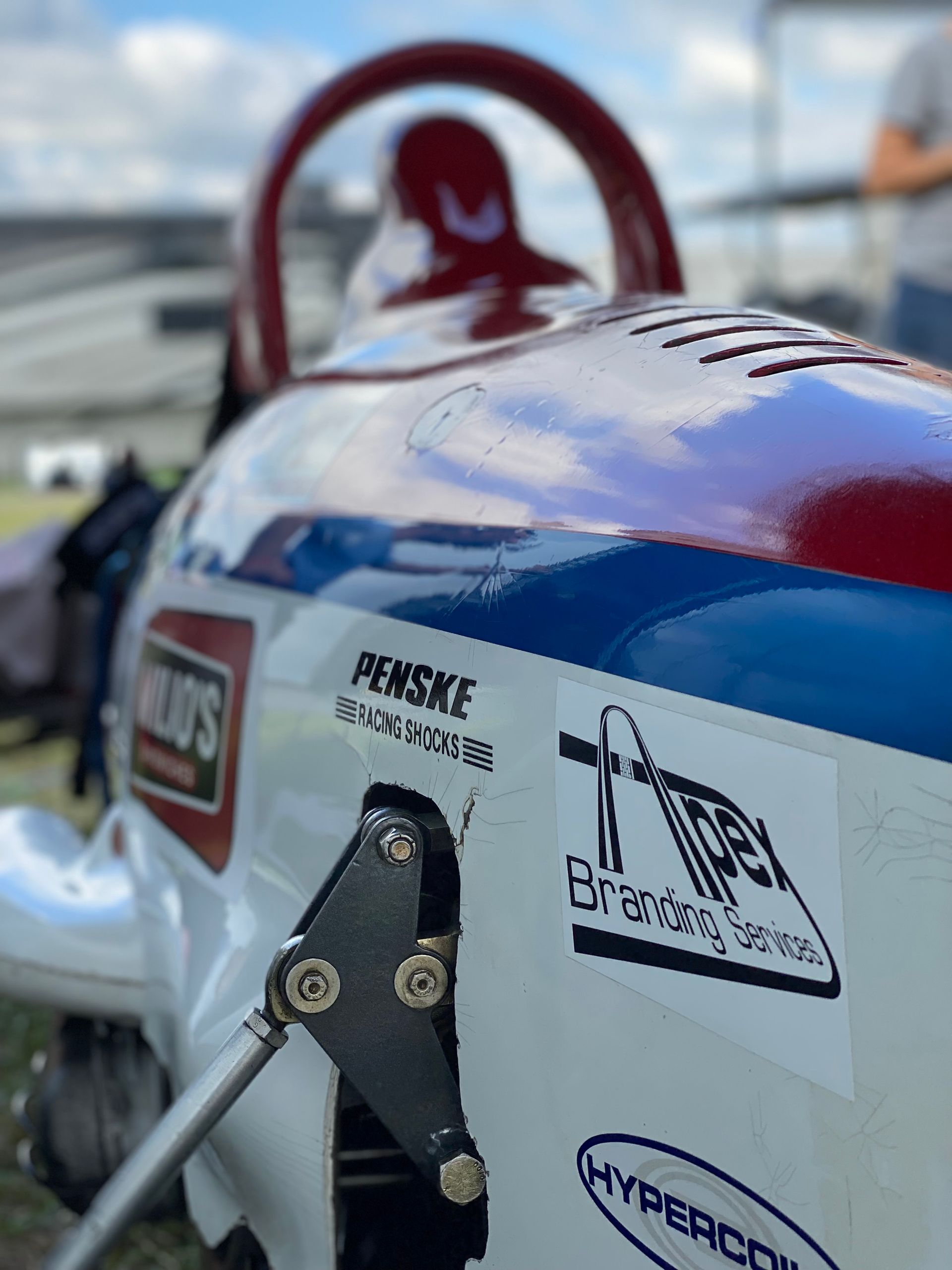 Race car sponsorship detail with bold brand decals