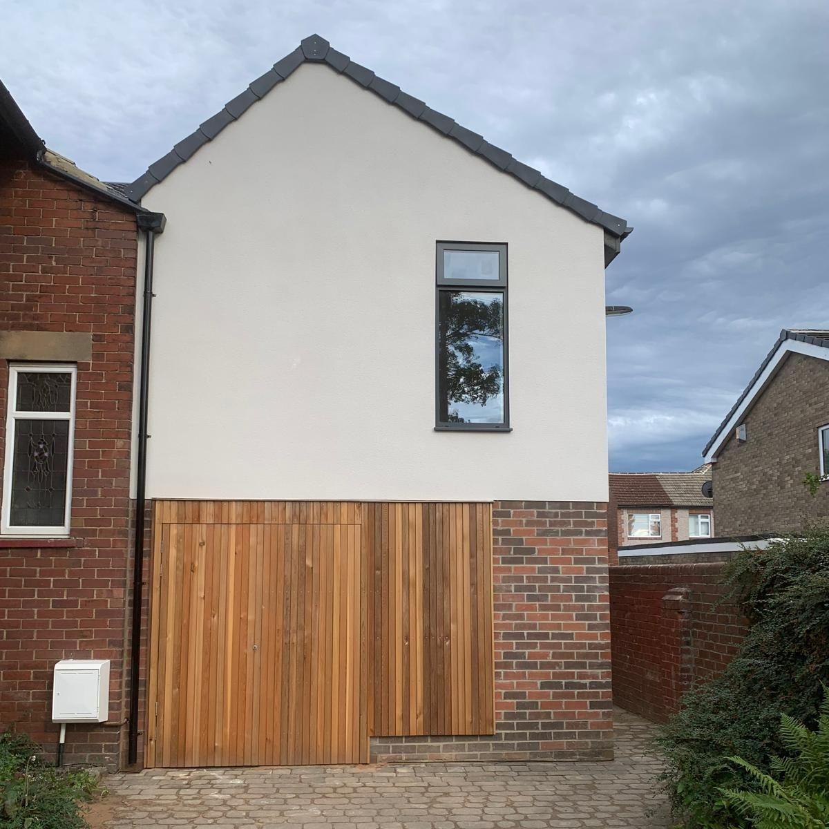 A white house with a wooden garage door