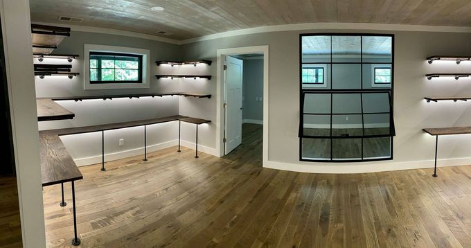 A large room with a lot of shelves and a window. A large room with a lot of shelves and a window.