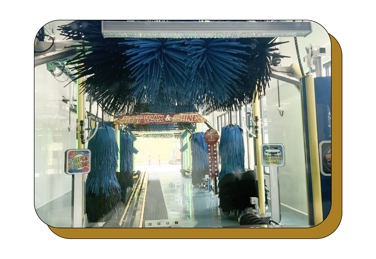 A picture of a car wash with blue brushes
