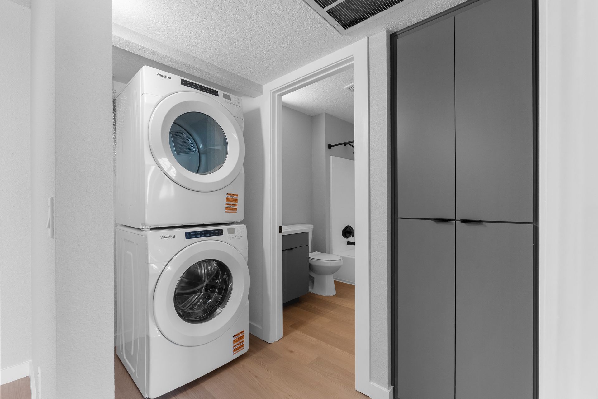 washer and dryer with open door to restroom