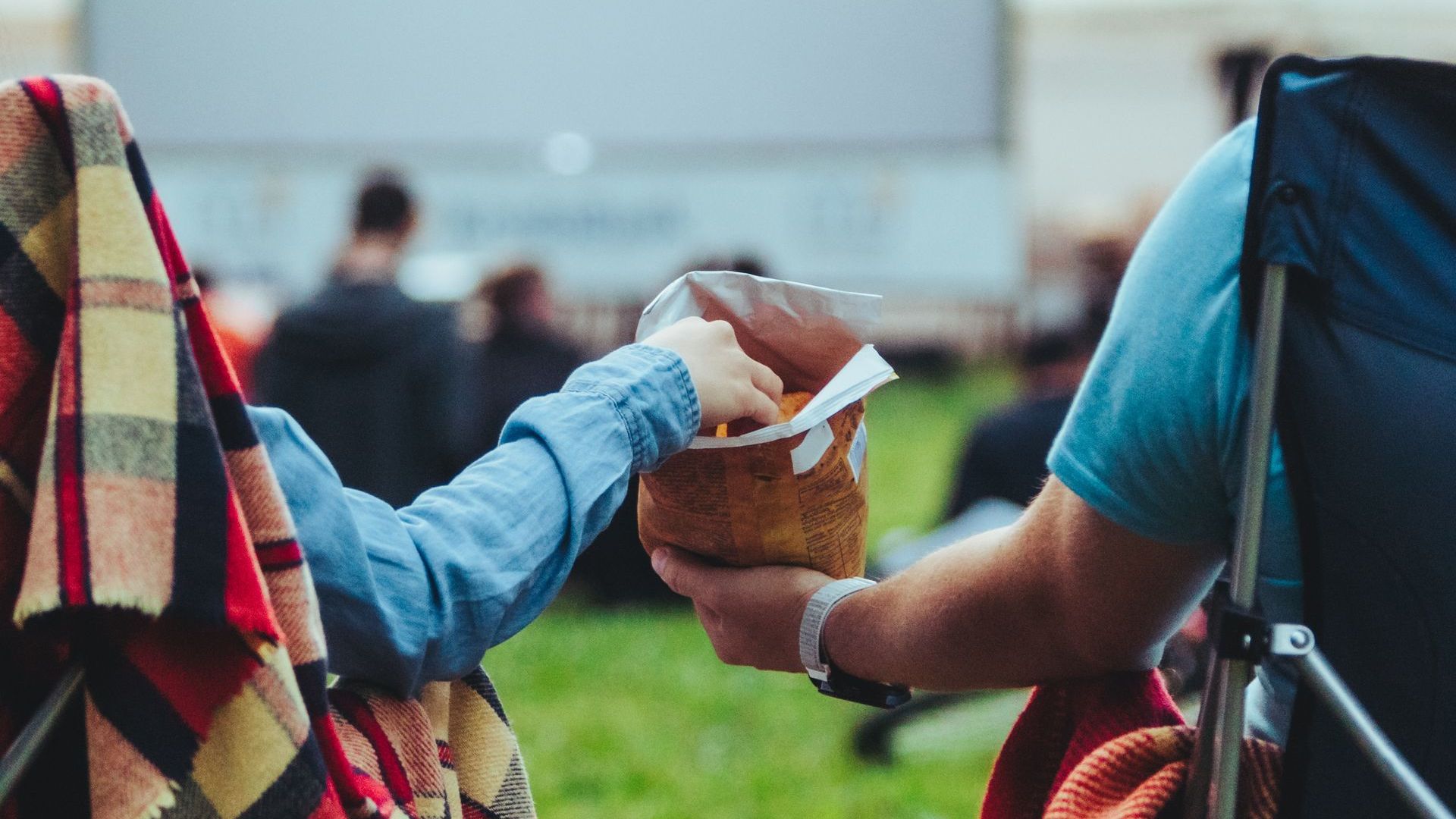 two people sharing a a bag of chips
