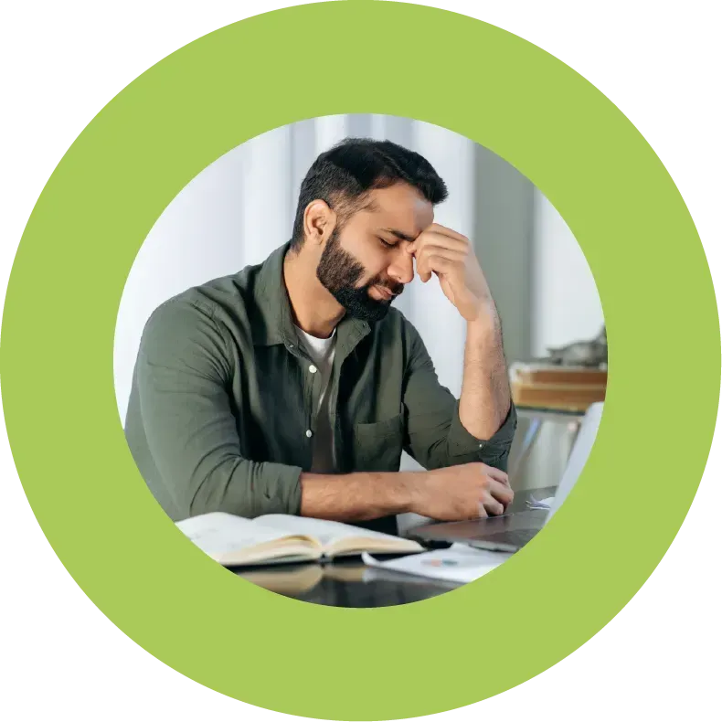 Tired-looking, exhausted male office worker at desk