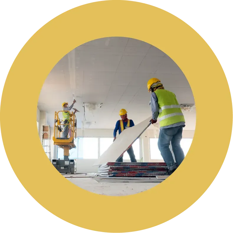 Construction workers installing ceiling panels