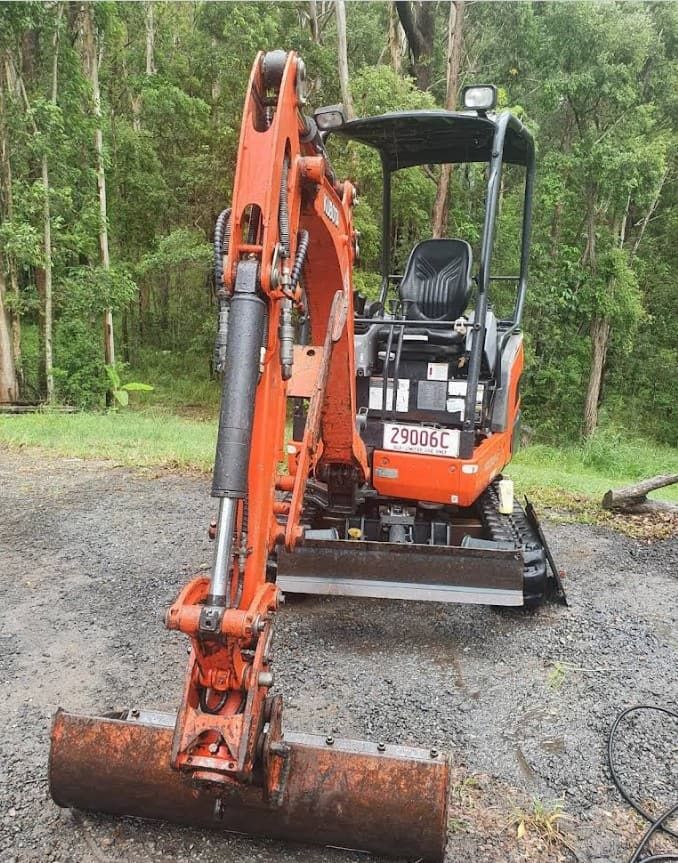 A Small Orange Excavator is Parked on a Dirt Road — Matt's Mini Machines in Bli Bli, QLD