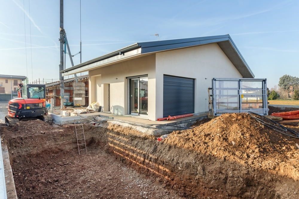 A House is Being Built With a Pile of Dirt in Front of It — Matt's Mini Machines in Yandina, QLD