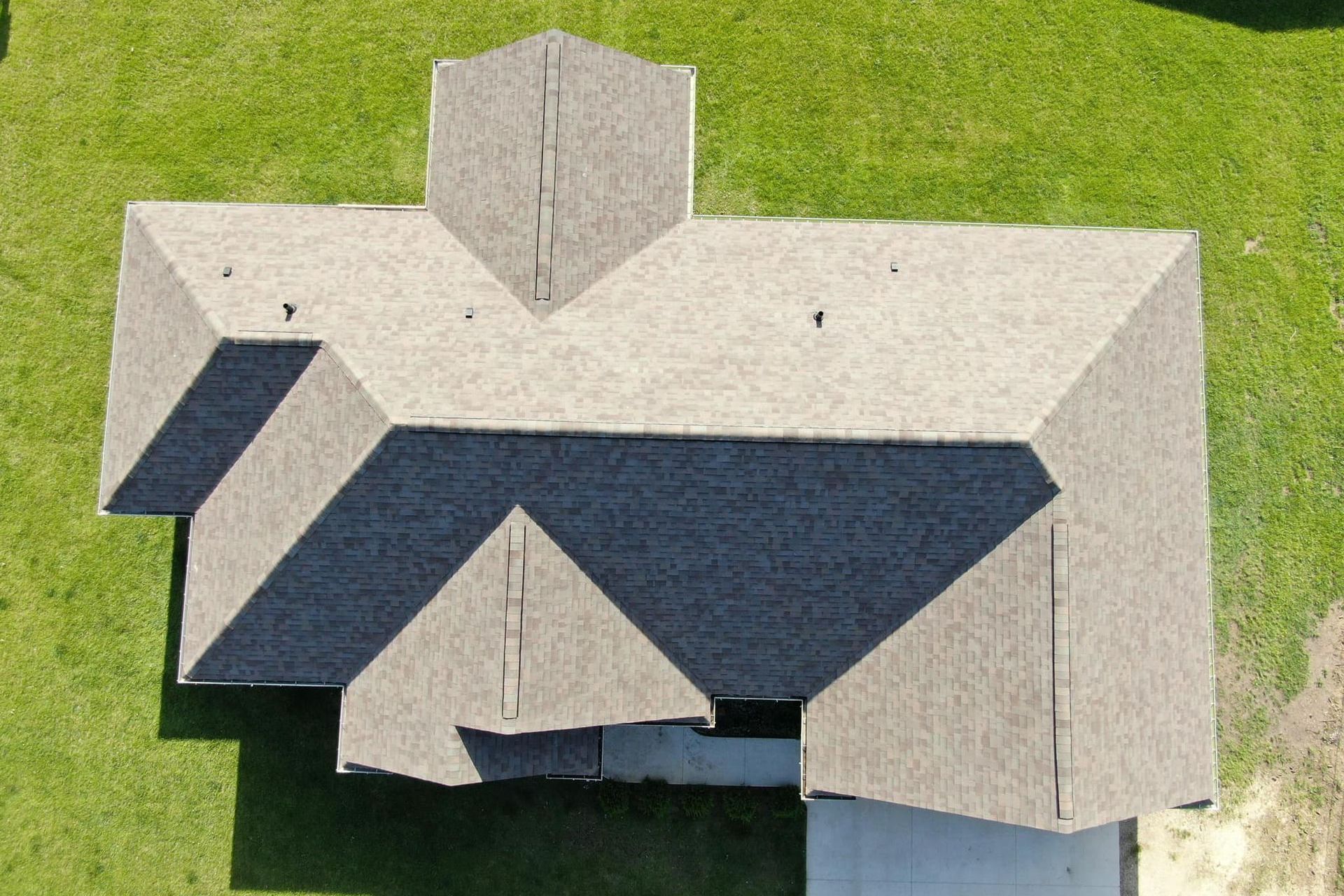 An aerial view of a house with a roof that is covered in shingles.