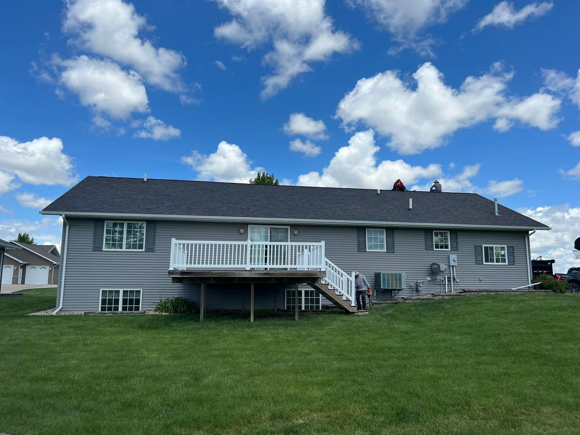 The back of a house with a large deck and stairs