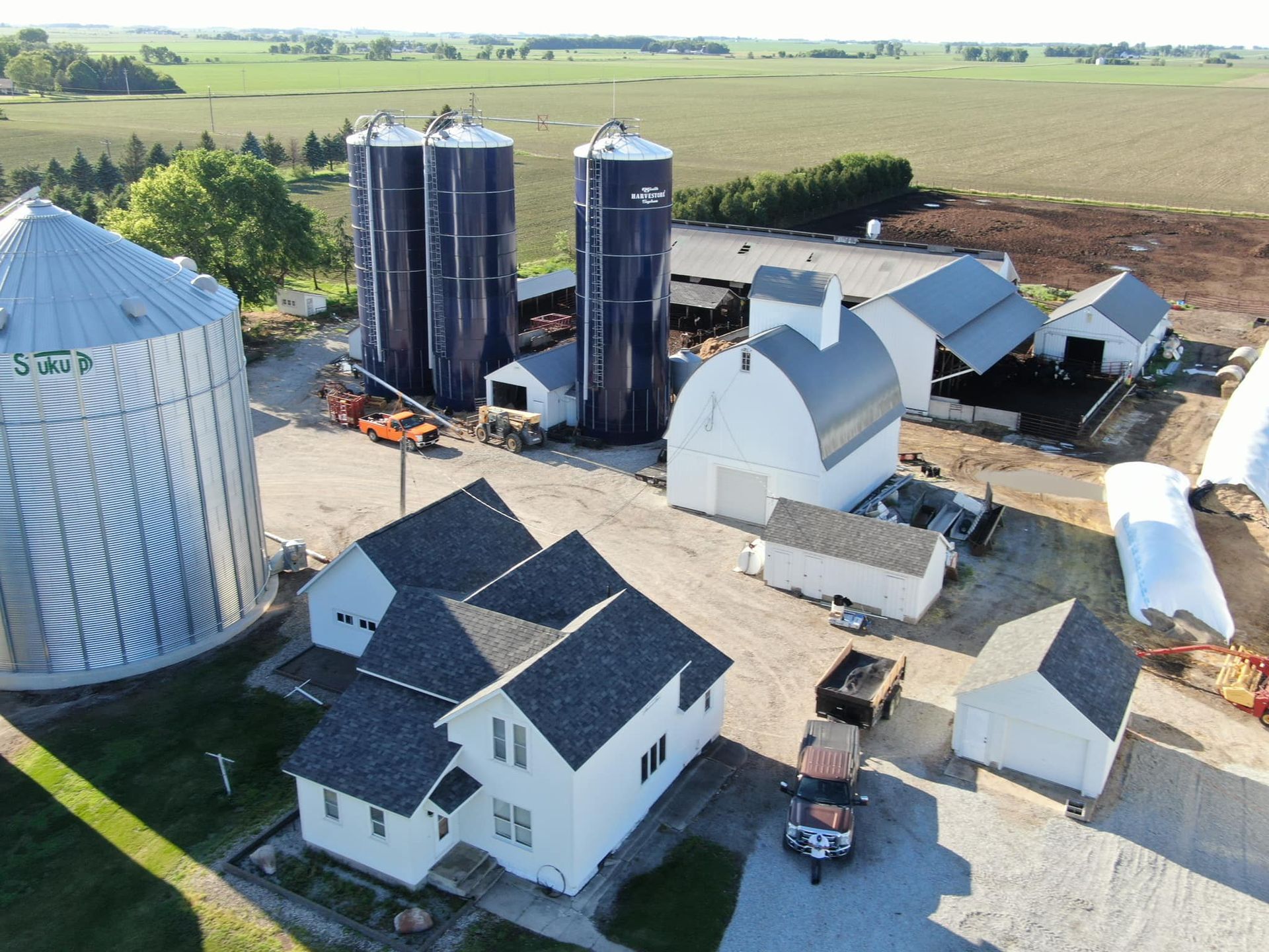 An aerial view of a farm with silos and houses