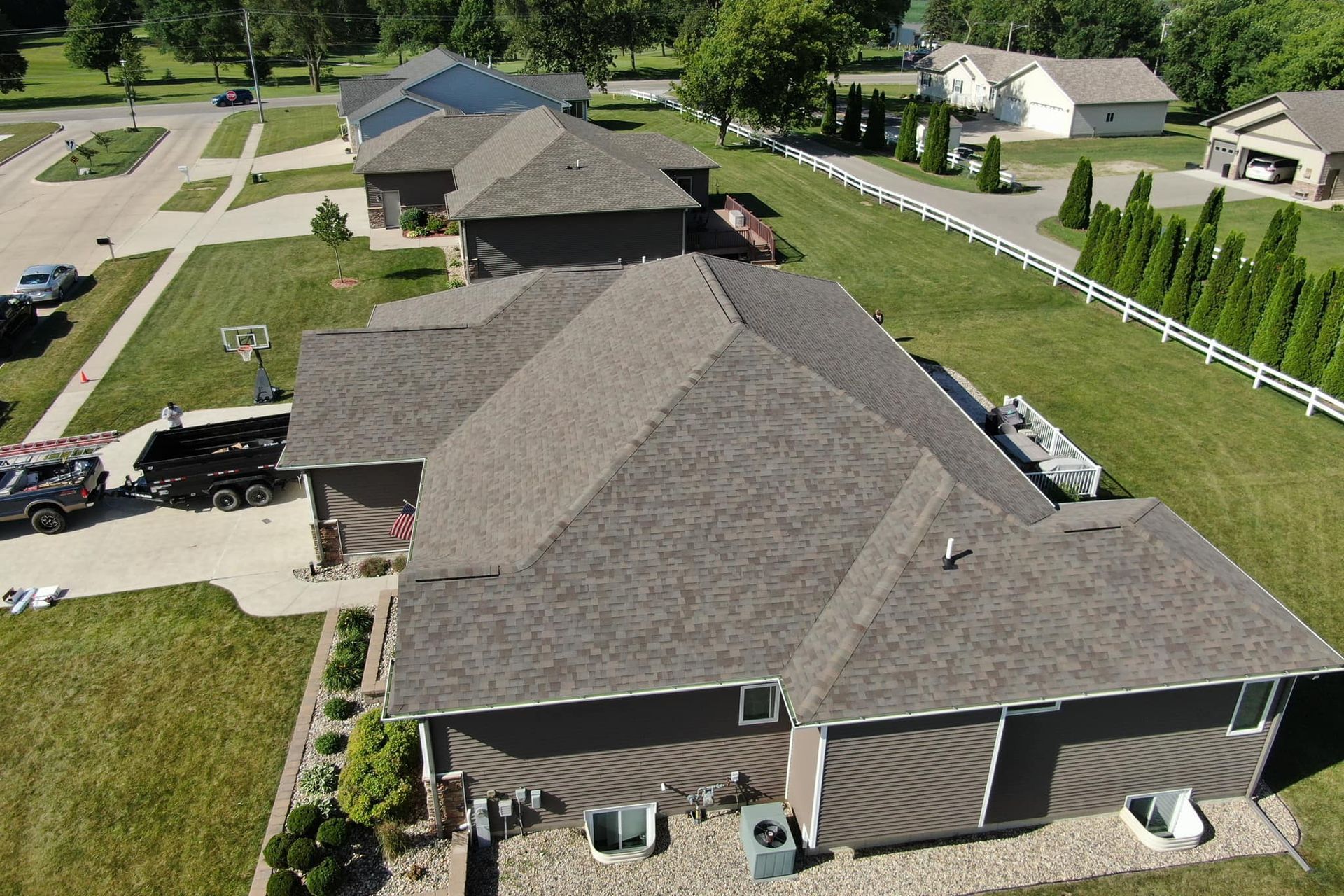 An aerial view of a house with a gray roof