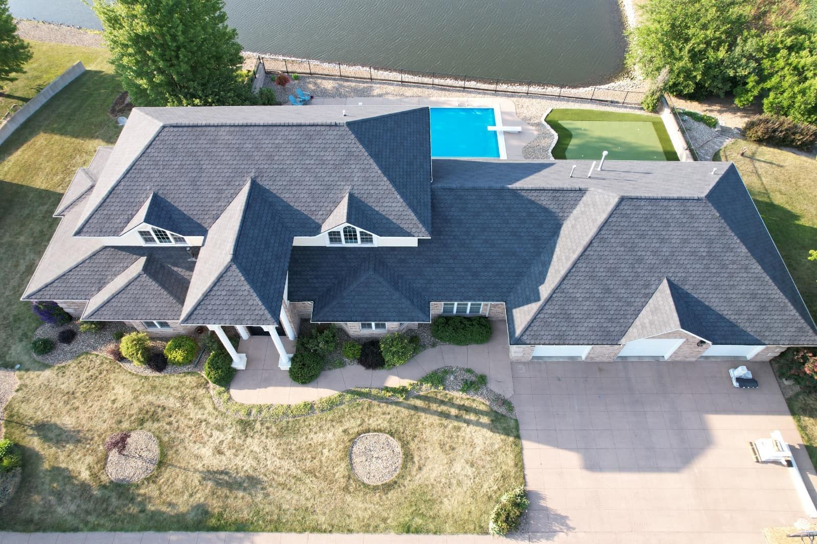 An aerial view of a large house with a pool in the backyard