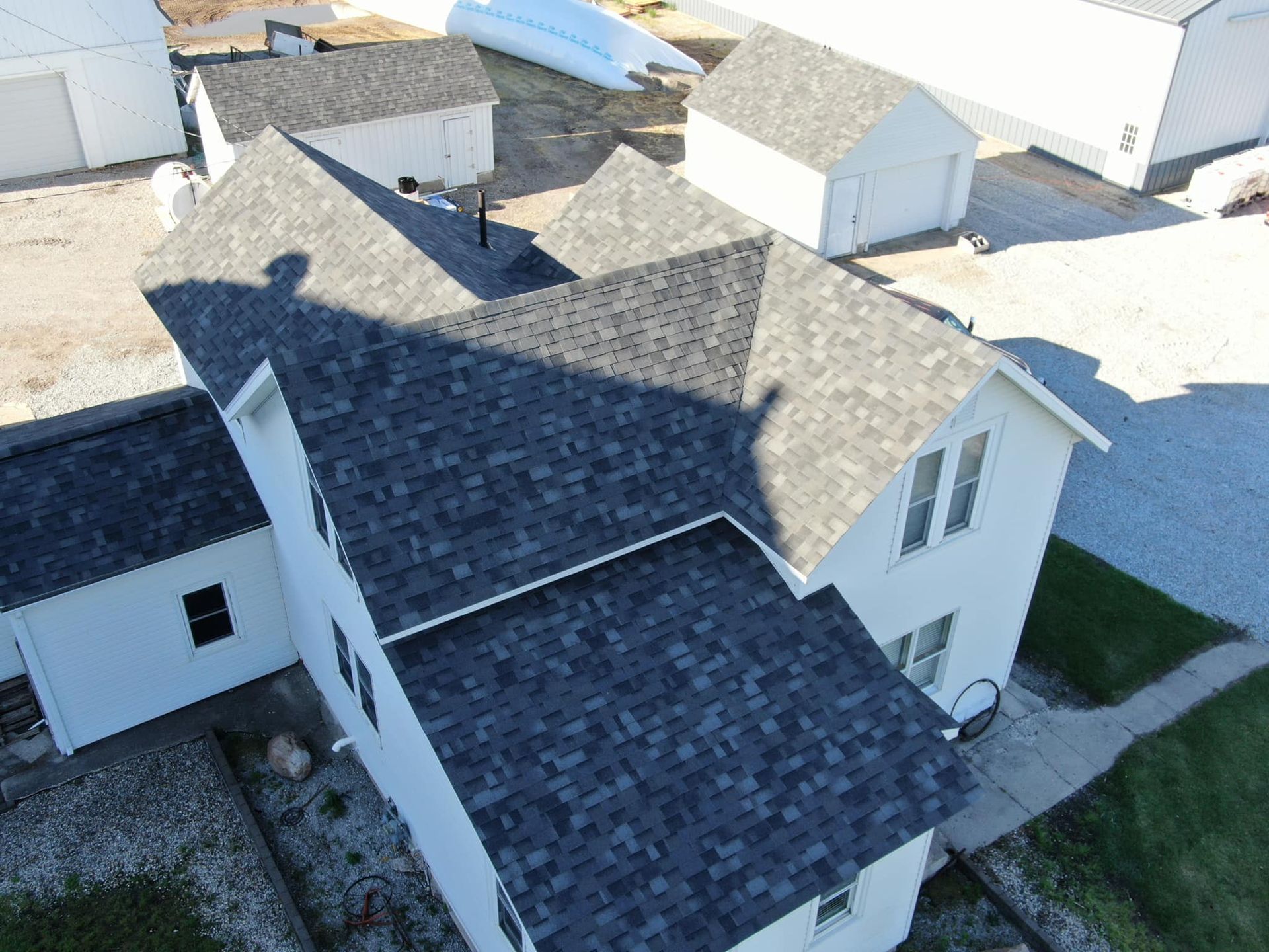 An aerial view of a house with a black roof