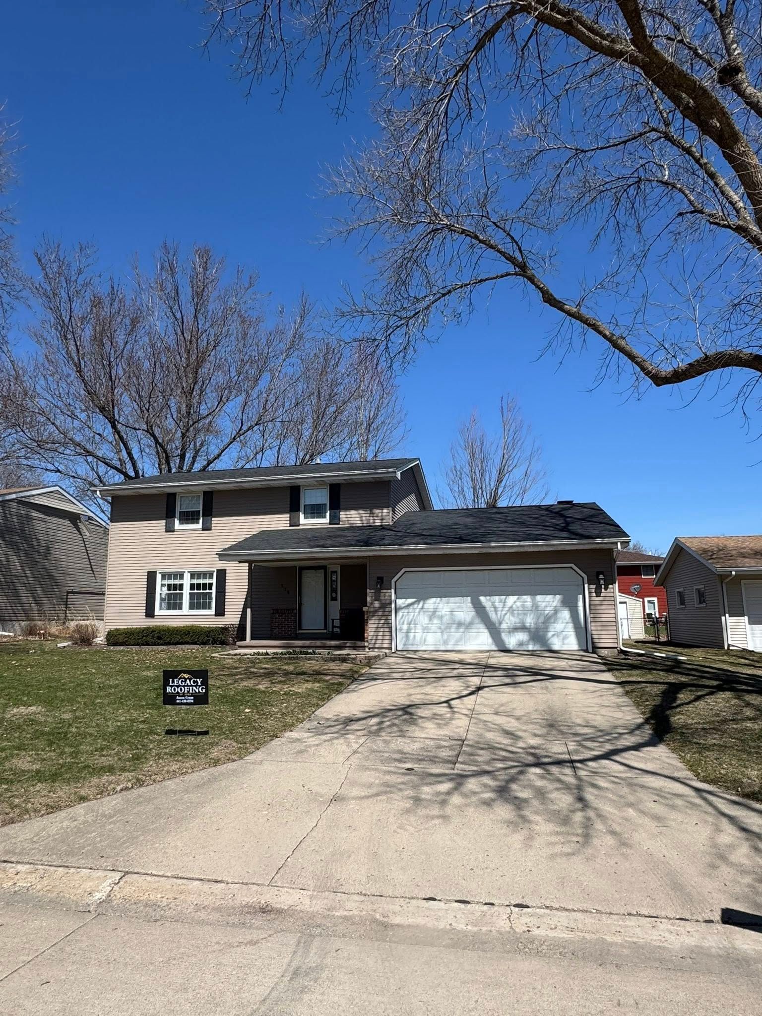 A house with a sign in front of it that says