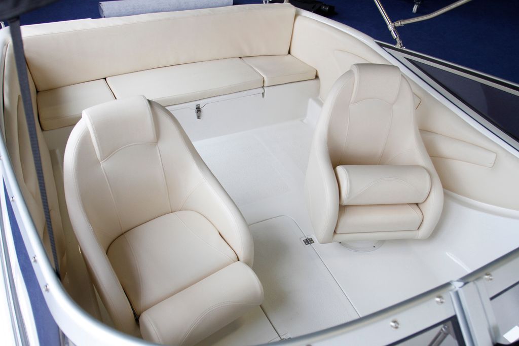 De binnenkant van een boot met witte leren stoelen