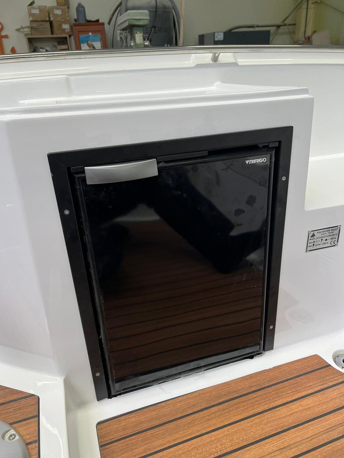 Een zwarte koelkast staat in een boot.